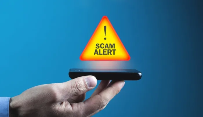 Man holding smartphone. Scam Alert