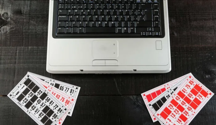 New Era for Online Bingo – ProgressPlay and Playtech’s Strategic Partnership Bingo cards and a laptopo on wooden background