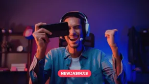 Exploring the Rise of Mobile Gaming Penetration in the UK Gamer wearing headphones playing video game online with smartphone, alongside a 'NEWCASINOS' logo in pink.