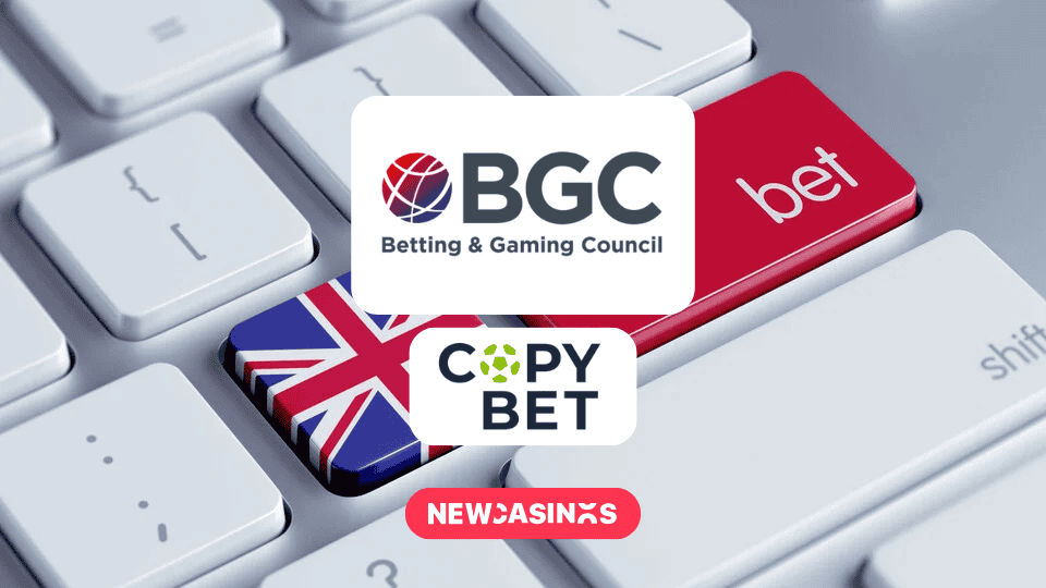 A close-up of a computer keyboard featuring two customized keys: one with the Union Jack flag representing the United Kingdom, and another larger red key labeled "bet," symbolizing online betting or gambling in the UK.