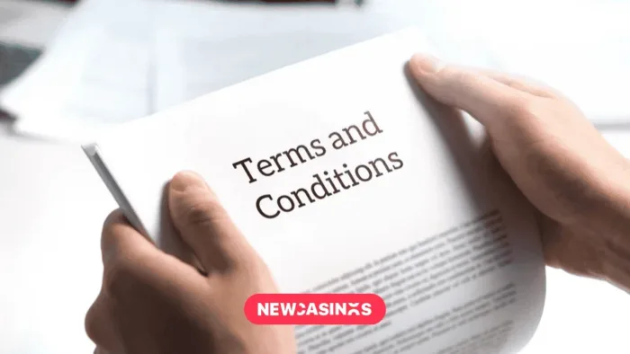 Hands holding a document with 'Terms and conditions' text in legal agreement or document about service policy.
