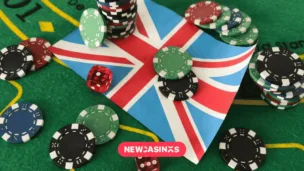 Dice with poker chips and playing card on background of the Union Jack flag.