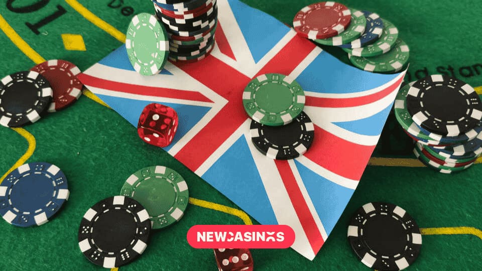 Dice with poker chips and playing card on background of the Union Jack flag.