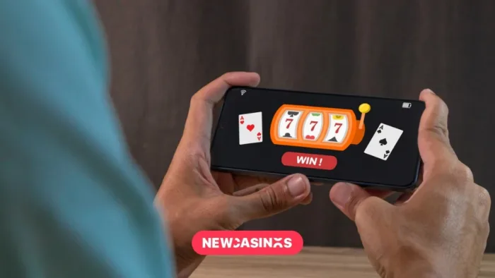 Hands holding a mobile device playing casino style games.