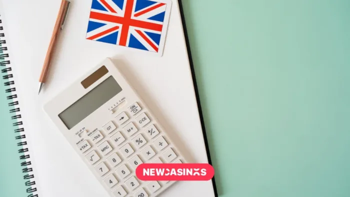 Calculator, Union Jack flag and pen on a table