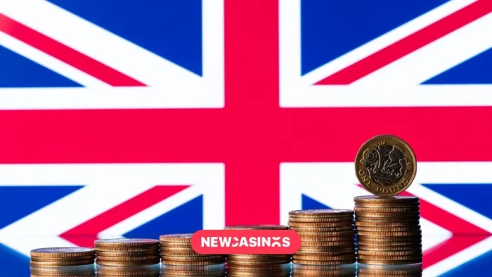A Union jack flag with piles of coins stacked in front. Featuring the NewCasinos logo