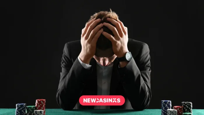 Self-Exclusion Systems Compared: Which Countries Protect Players Best? Man sat with his head in his hands at the poker table, the New Casinos logo is visible.